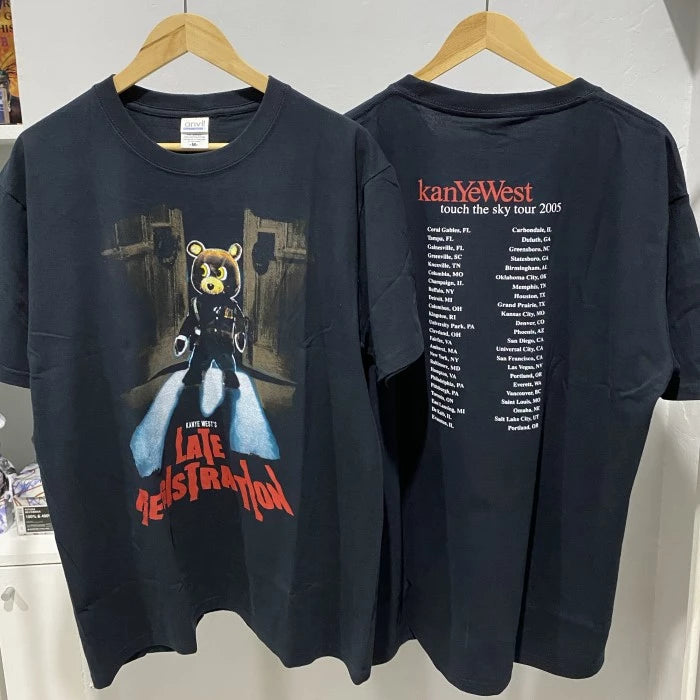 Black 'Late Registration' and 'Touch the Sky Tour 2005' T-shirts featuring Kanye West album art and tour date details for music merchandise collection.
