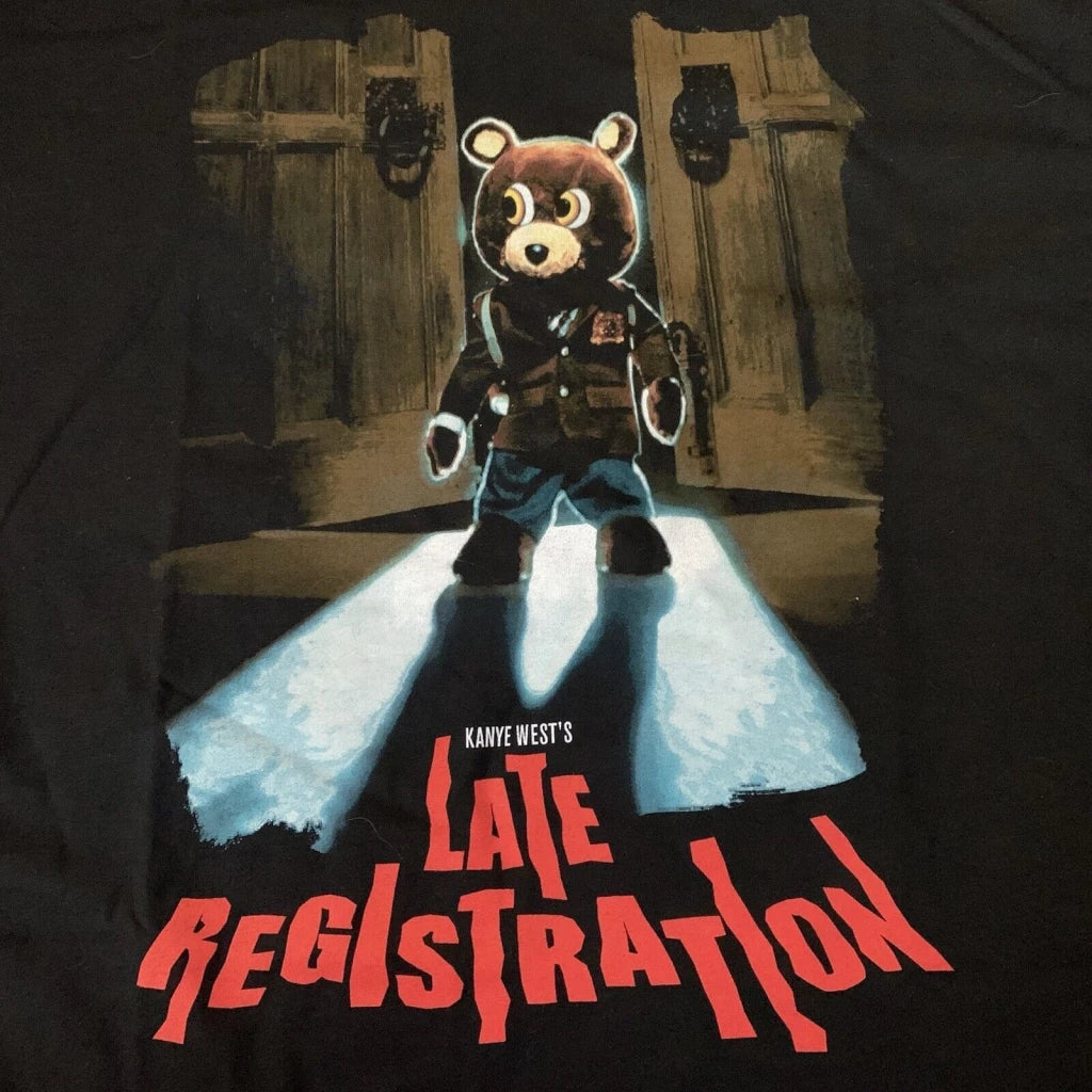 Graphic t-shirt featuring a stylized bear mascot in a spotlight, representing Kanye West's 'Late Registration' album, with bold red text.