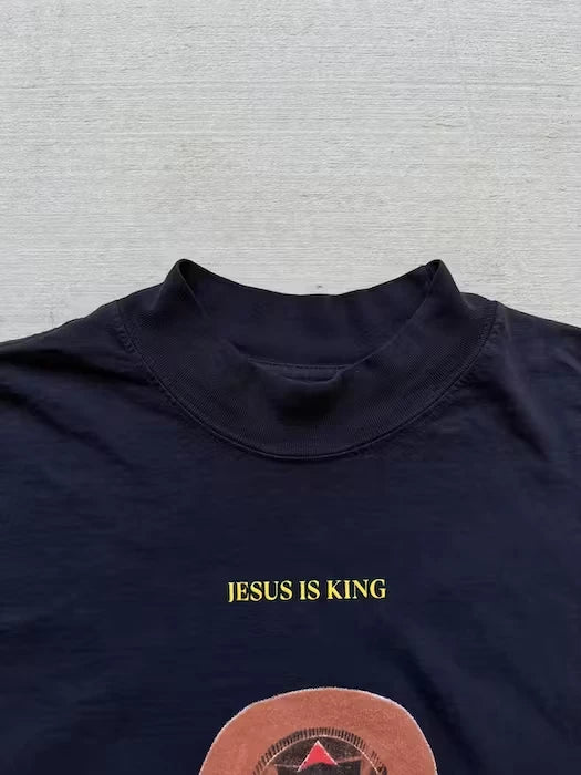 Navy blue t-shirt featuring the 'Jesus is King' album art with vinyl record design, showcasing Kanye West's iconic bear mascot in a crown, emphasizing the album's gospel influence.