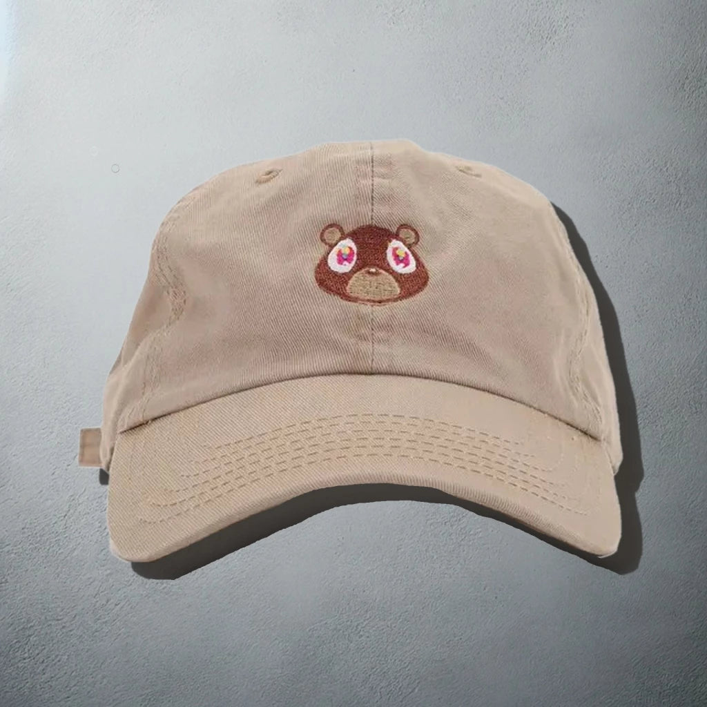 Beige baseball cap with an embroidered bear face, inspired by Kanye West's 'Graduation' album artwork