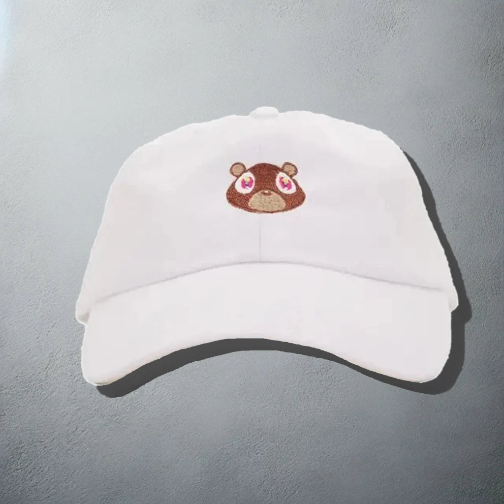 White baseball cap with an embroidered bear face, inspired by Kanye West's 'Graduation' album artwork