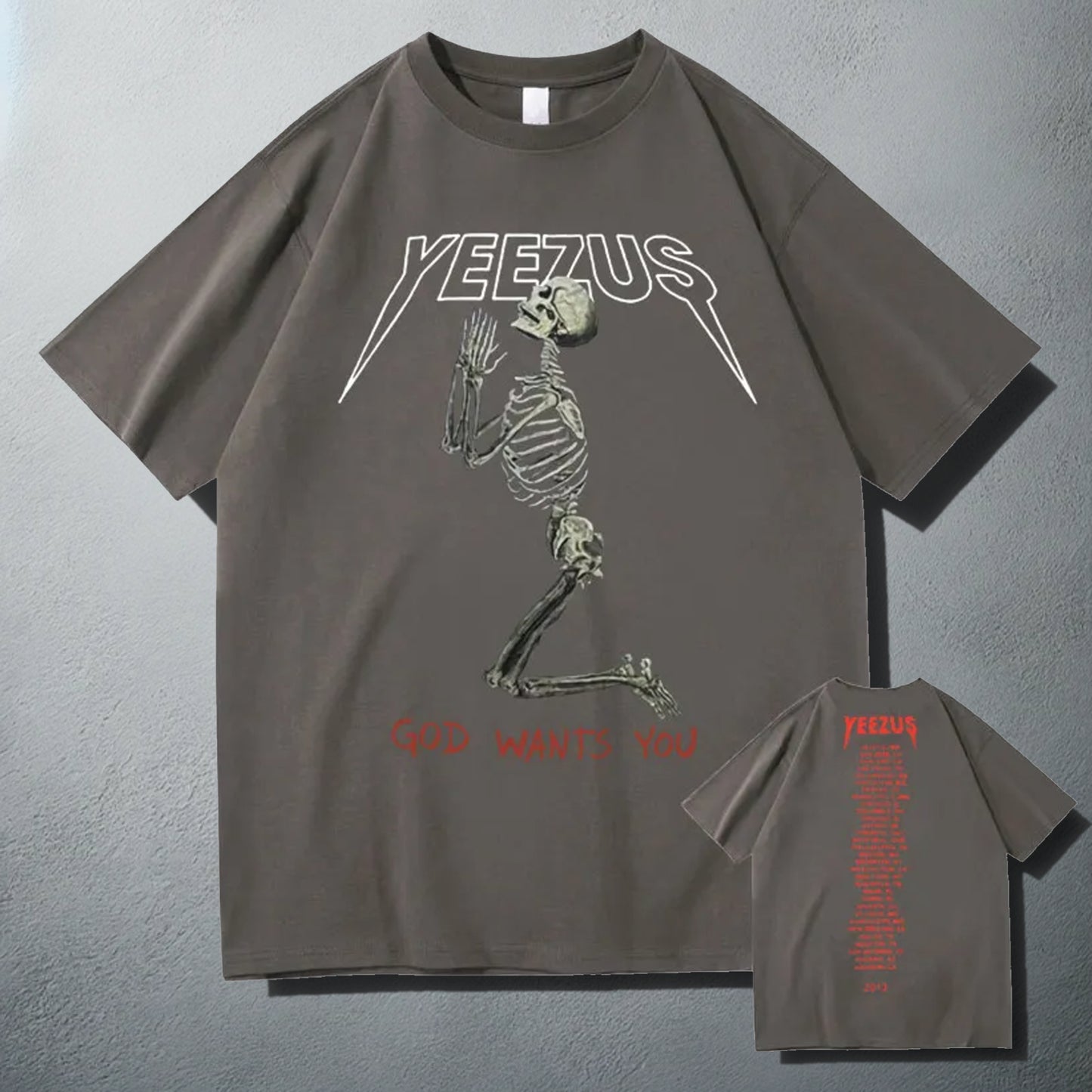 Dark Grey 'Yeezus' T-shirt with a white praying skeleton graphic and 'God Wants You' text, showcasing a bold design inspired by Kanye West's album