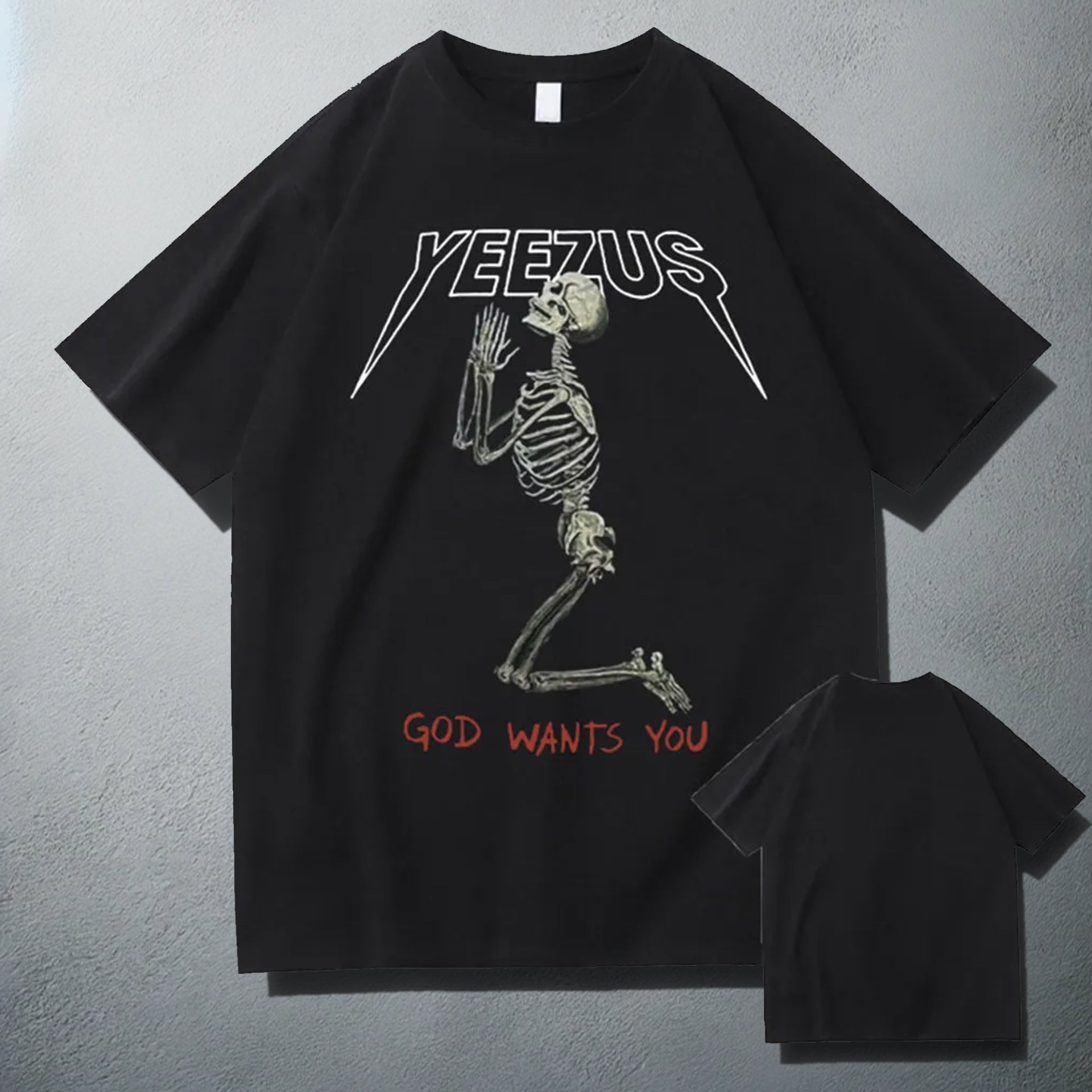 Black 'Yeezus' T-shirt with a white praying skeleton graphic and 'God Wants You' text, showcasing a bold design inspired by Kanye West's album