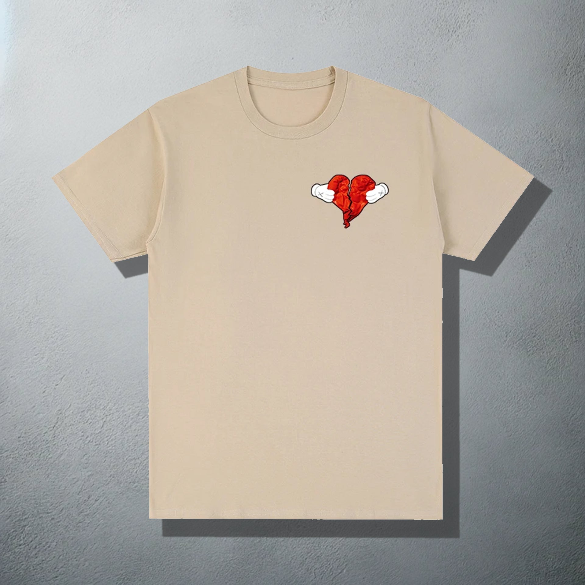 Beige T-shirt featuring a 'Heartless' inspired red heart with wings graphic, referencing Kanye's '808s & Heartbreak' album